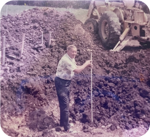 Photo of William "Mac" McGee working on constructing a custom pool.